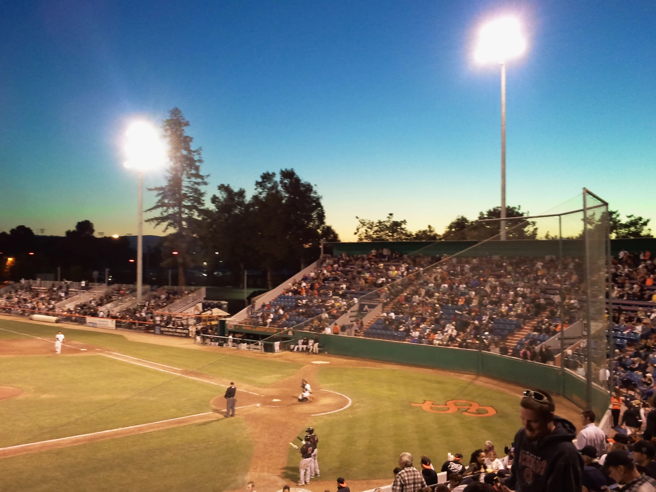 baseball game with an infield and large crowd