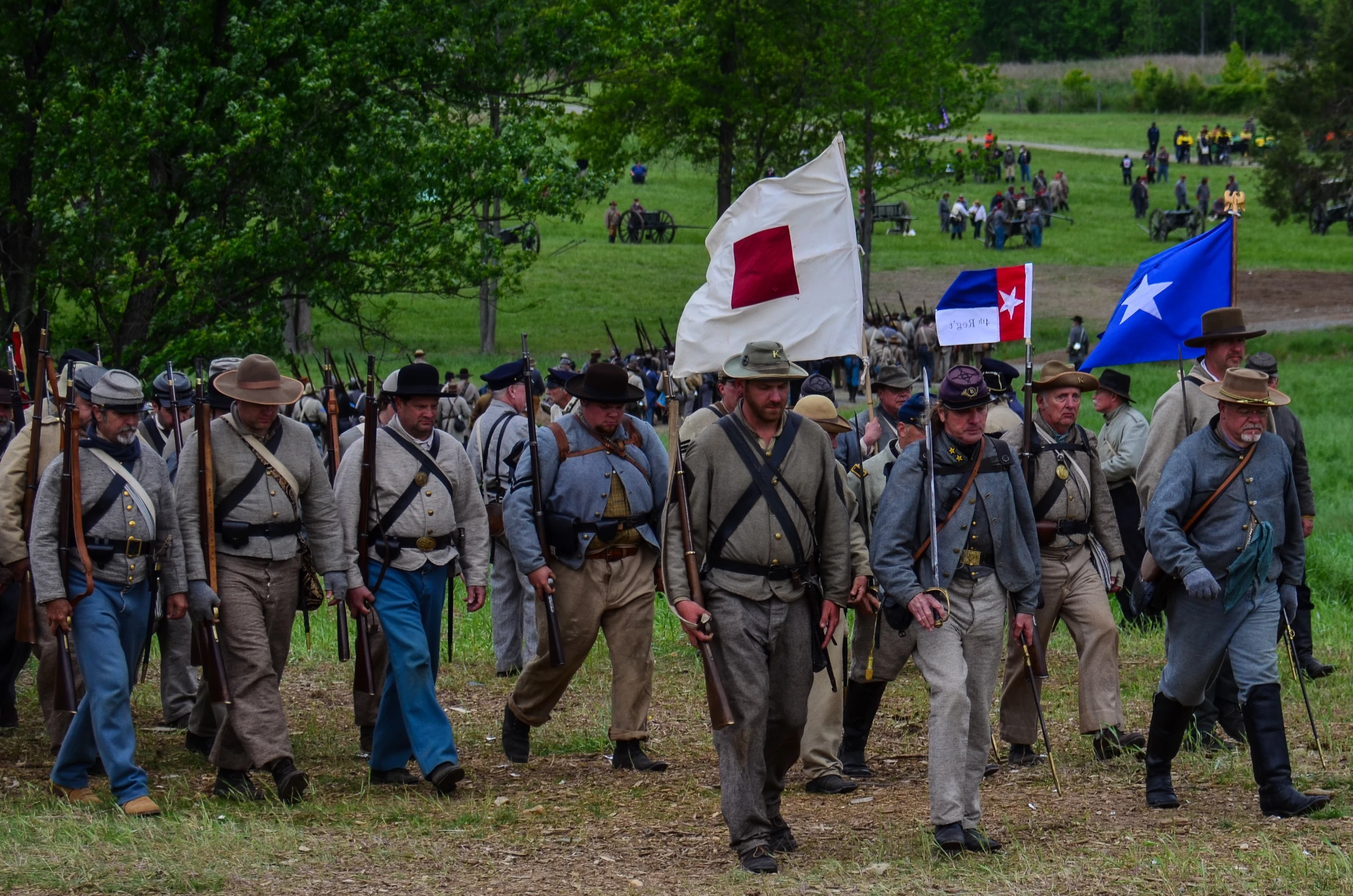 a bunch of people with some flags and boots