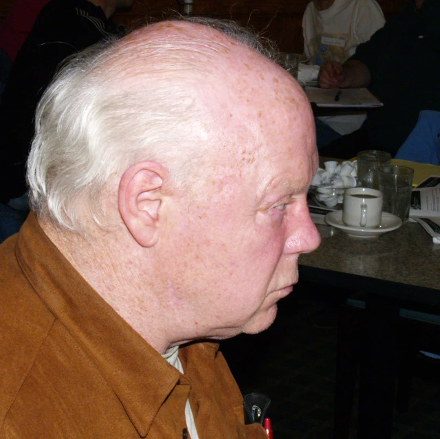 a person sitting at a table near many food dishes