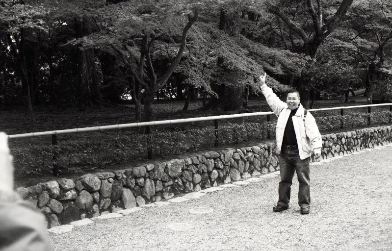 a man waving to a lady in the distance