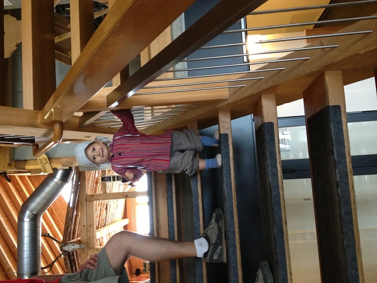 a man standing next to a toddler on top of a staircase