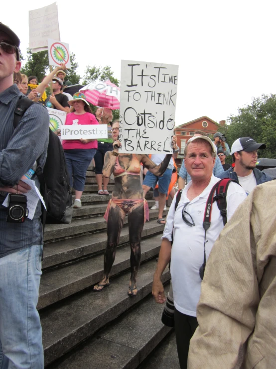 a dog is being held in front of people with protest signs