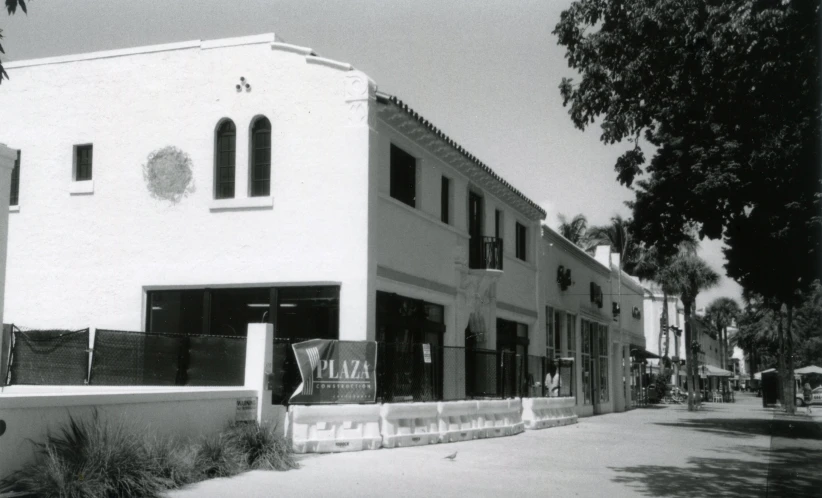 a large white building with a fence near by