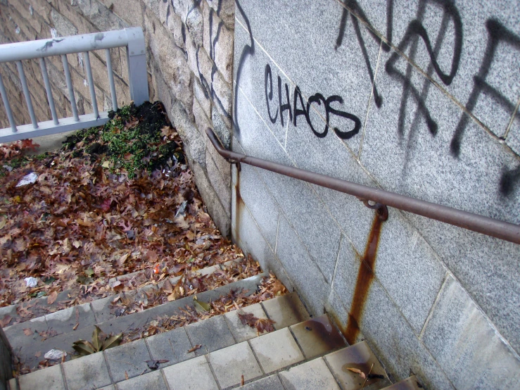 graffiti is displayed on the concrete walls on this stairs