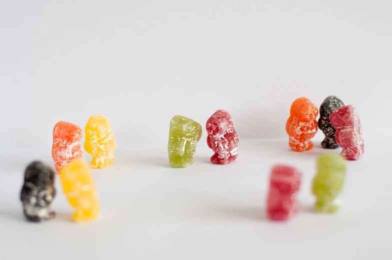 a group of colorful candies sitting in the middle of a white background