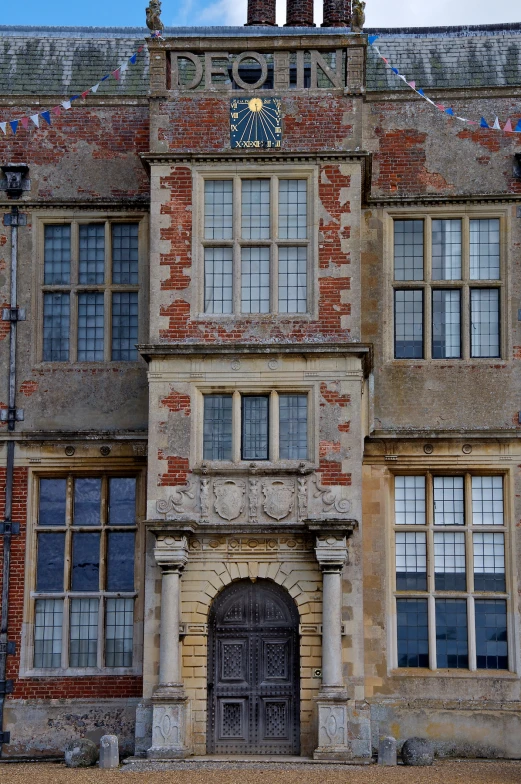 an old brick building with lots of windows and a clock