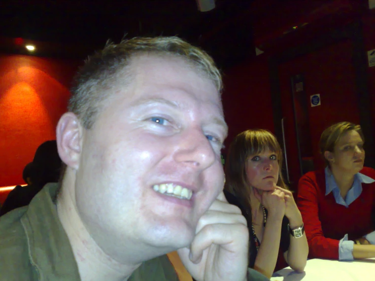 two women and one man sitting at a restaurant