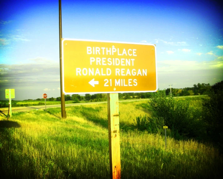 an old road sign telling us where birth place is