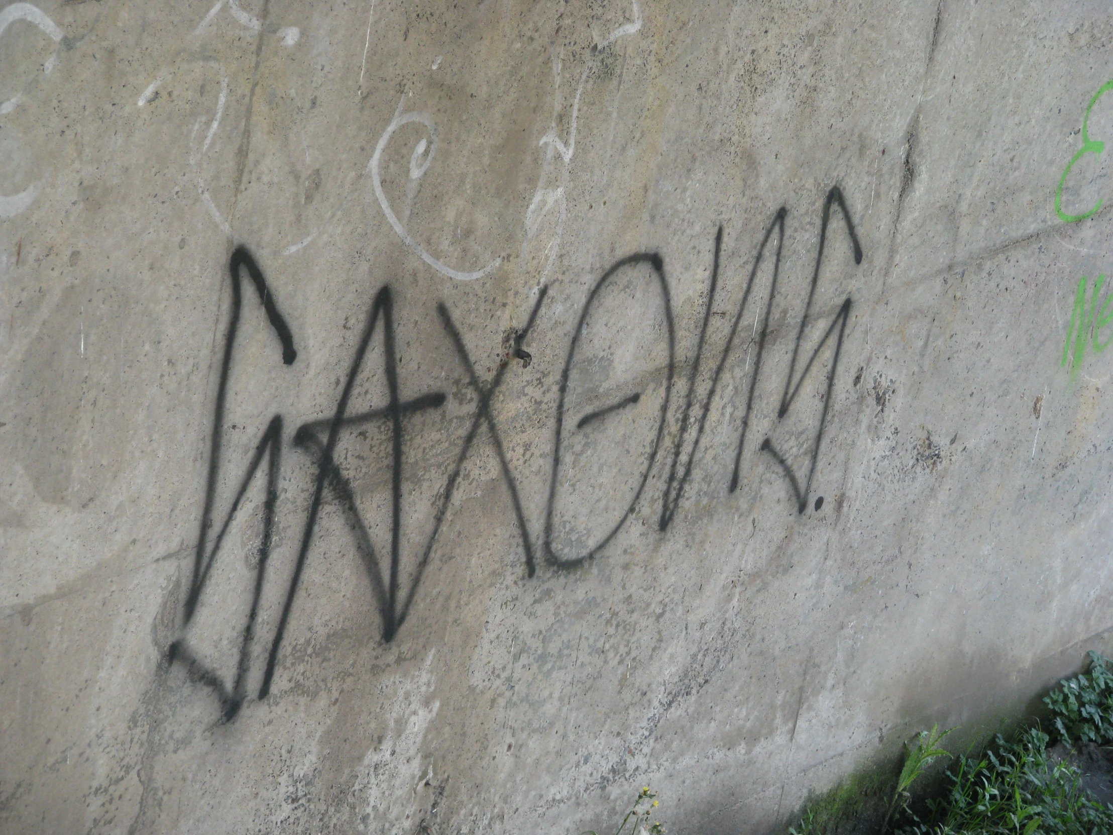 graffiti spray painted on a concrete wall in the daytime