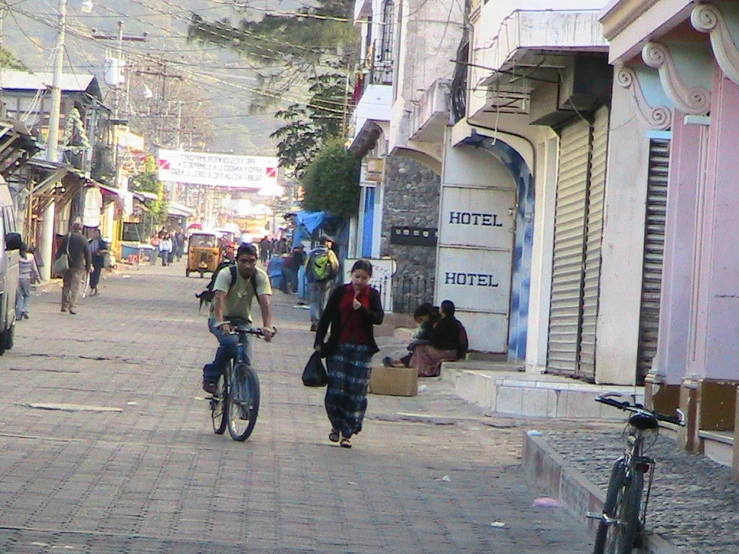 people on bicycles and a bicyclist going down a street