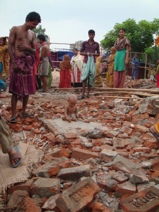 a group of people gather together in the rubble