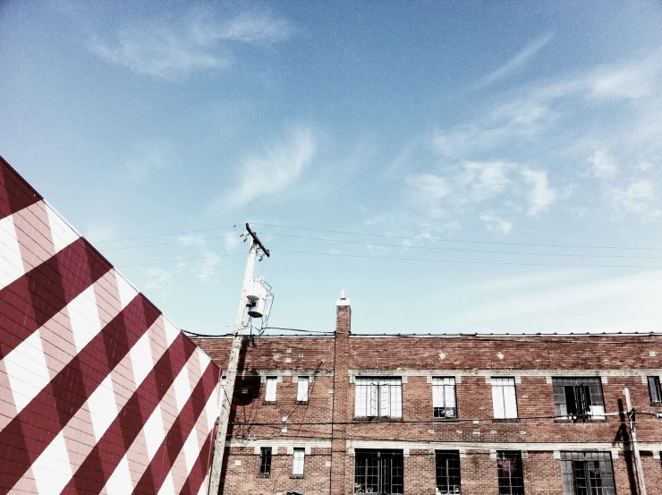 two buildings with flag and street light pole in foreground