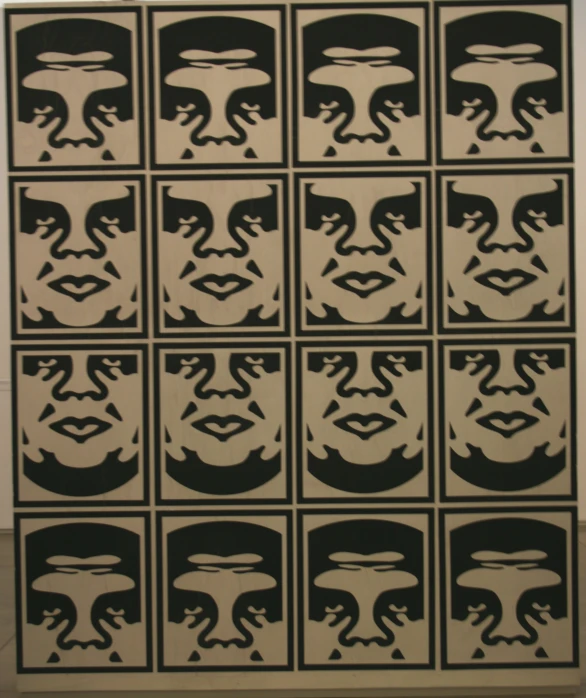 a black and white image of four faces on a large panel