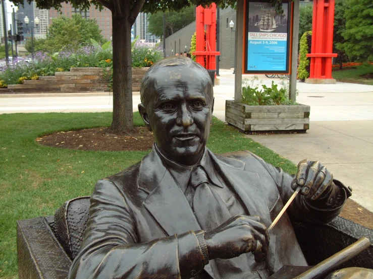 a statue is holding a broom and potted plant