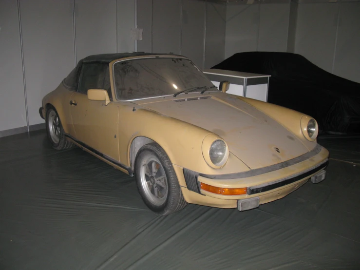 a yellow and brown parked next to a car