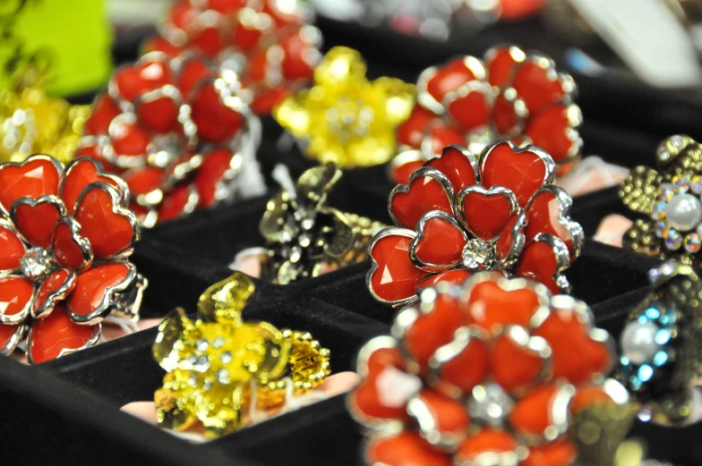 several rings and brooches in a display