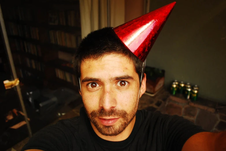 a man wearing a red hat sitting down