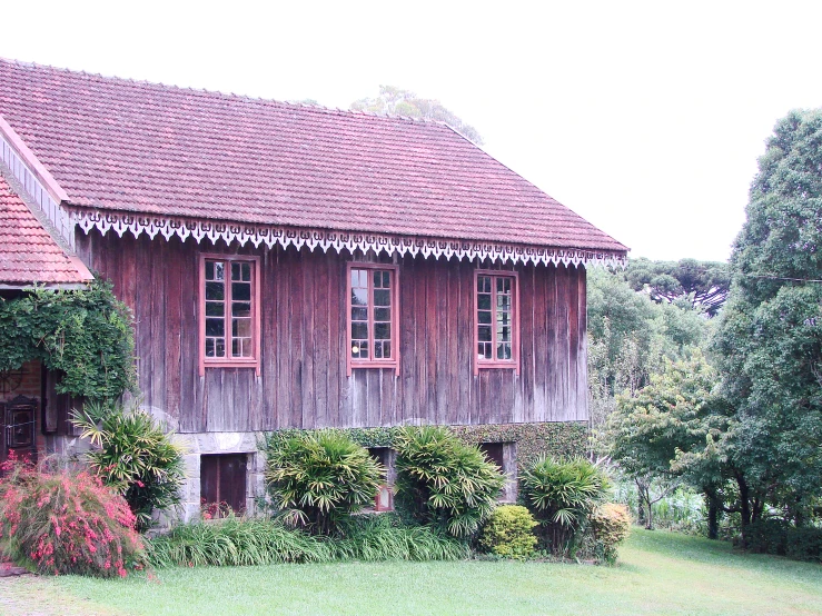 a very nice old wooden house with vines surrounding it