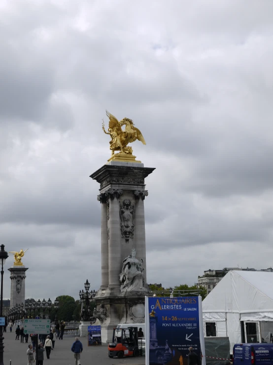 a big statue with golden statues on top of it