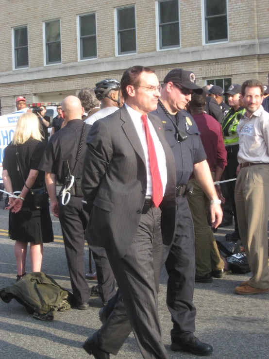 a man in a suit walking through the street