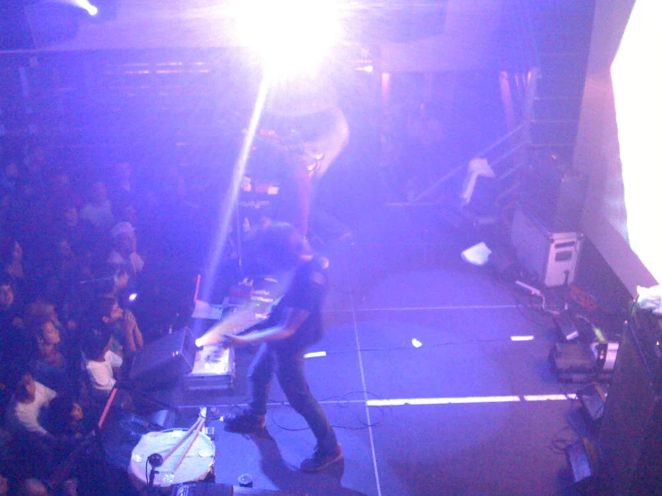 people are watching as a band performs on stage