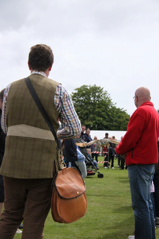 people are gathered together on the grass at the event