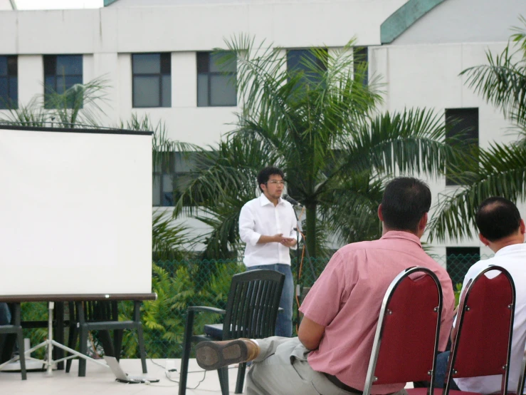 a man speaking to a group of people