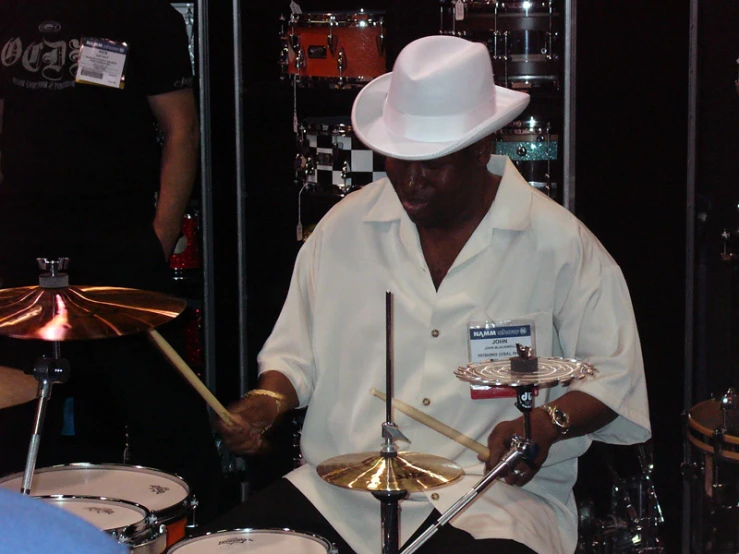 a drummer sitting in front of some drums