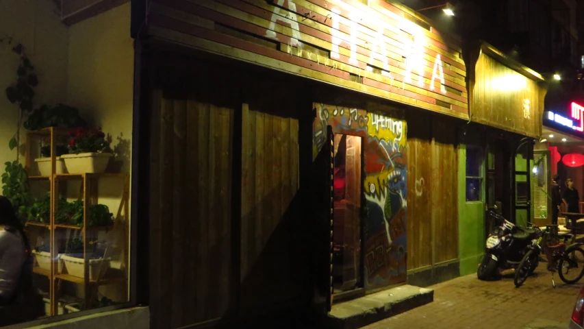 the shop front of an asian restaurant at night