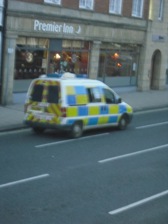 an ambulance is painted in bright blue and yellow colors