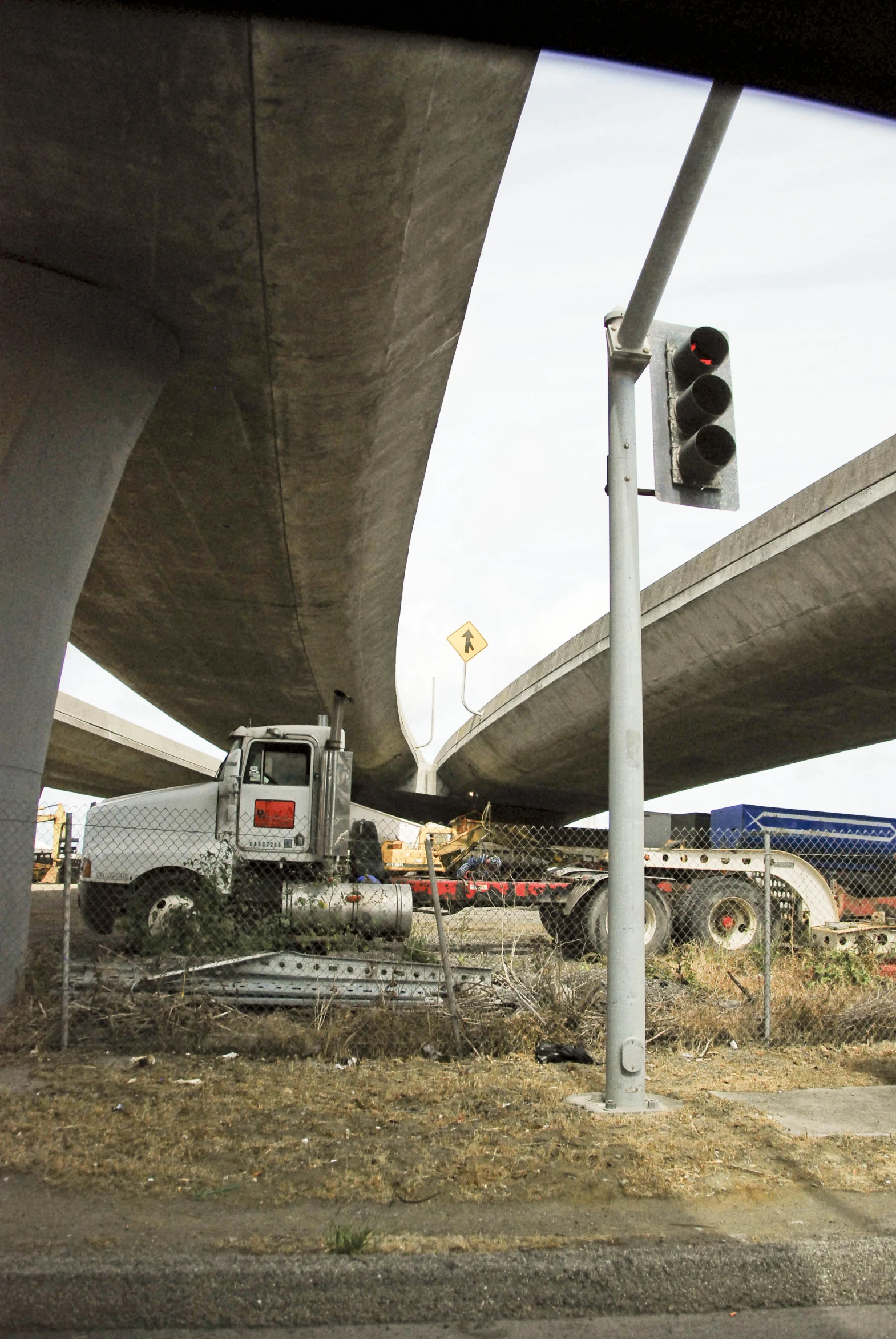 a street light is posted under a bridge