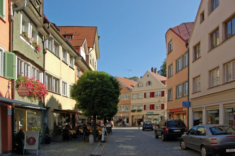 a small narrow street with people walking down it