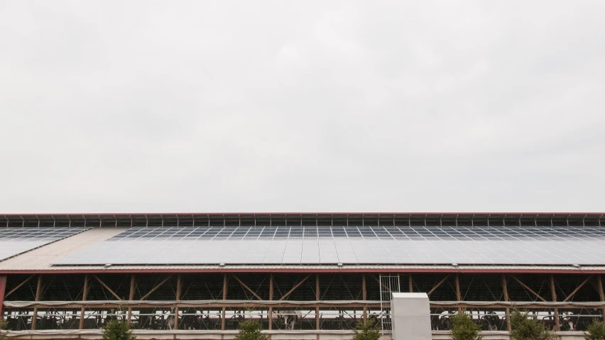 an industrial building with solar panels on the roof
