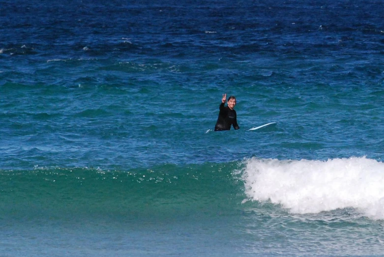 a person in the ocean holding a surfboard