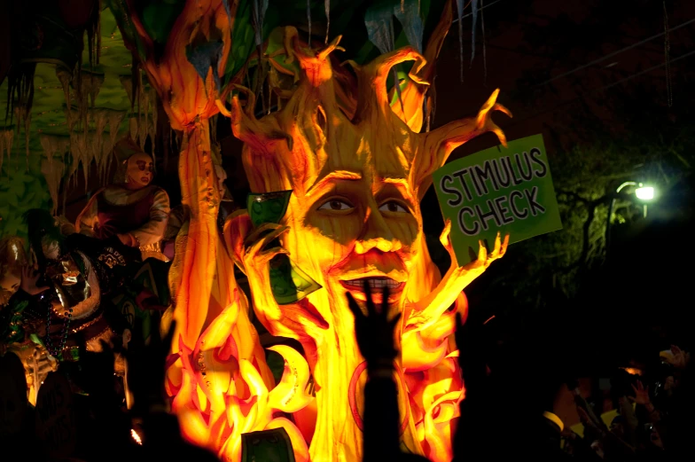 several masks made of flames and trees with glowing lights around them