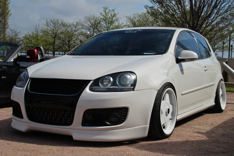 a white car is parked near another car