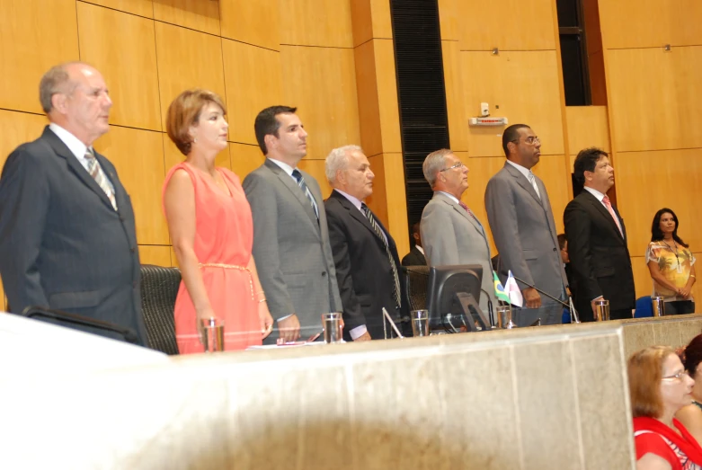 the panelists are standing for a meeting