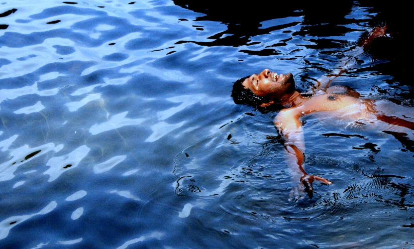 a person floating in the water on a clear day