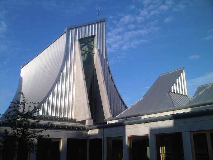 a church designed with metal shingles and tall buildings