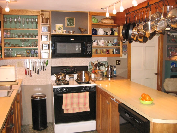 a kitchen with a black stove top oven sitting next to a refrigerator