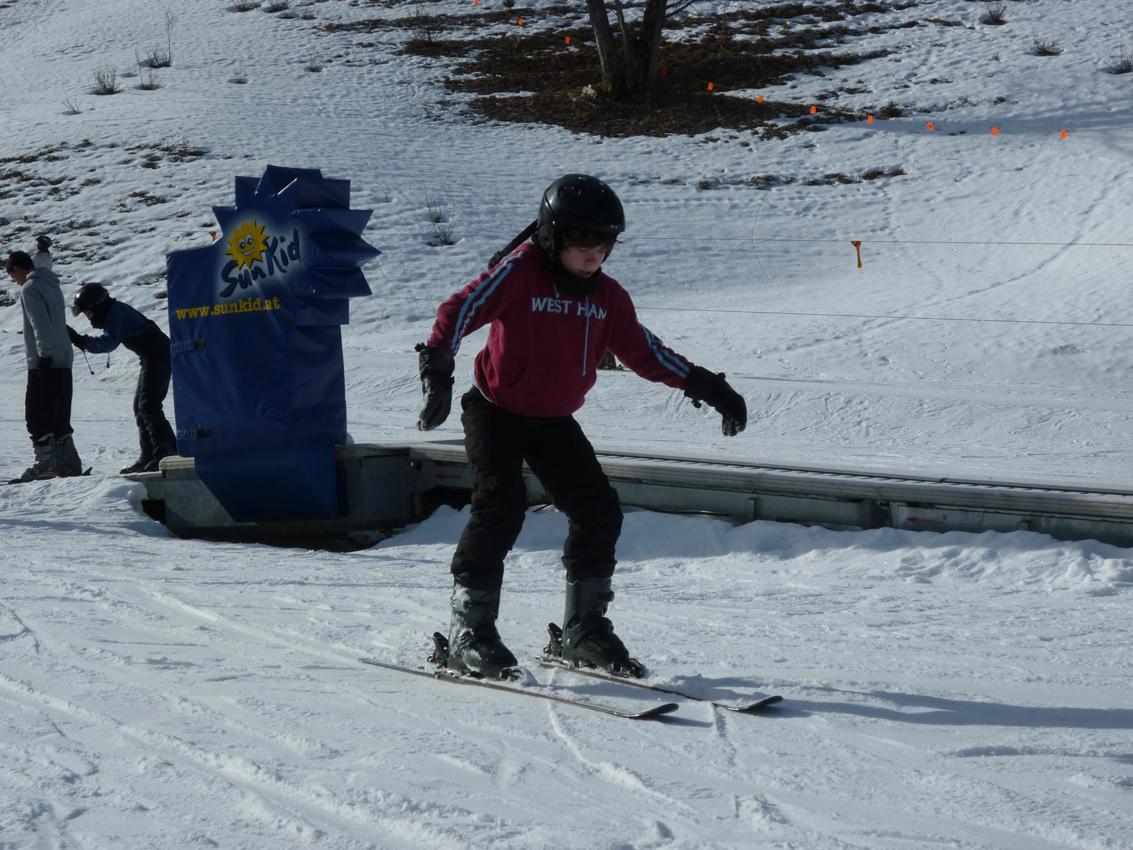 people skiing on the snow covered slopes near the gates