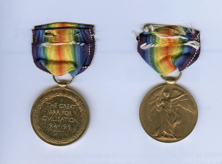 a couple of medals sitting on top of a white surface