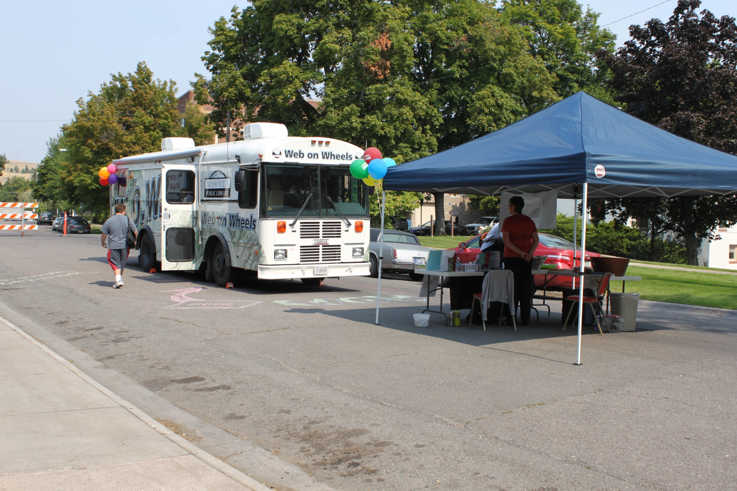 the food truck is parked in the middle of a paved street