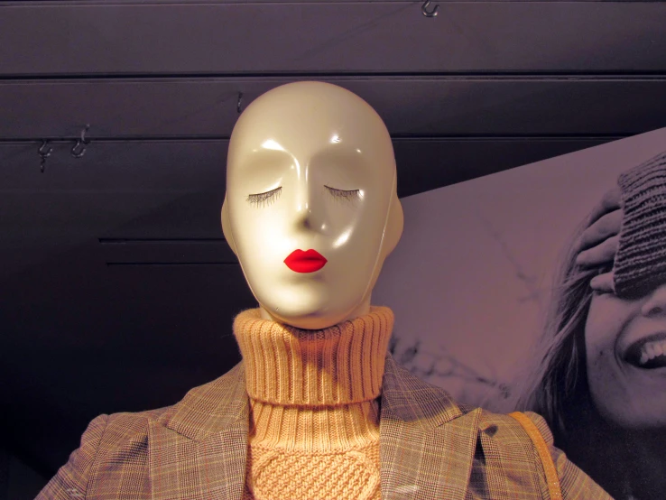 a mannequin has a knitted outfit and lipstick on