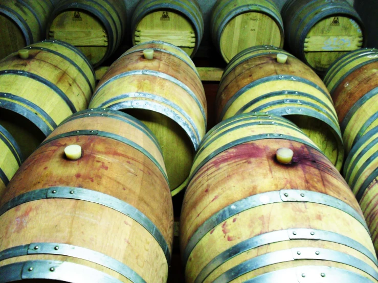 several wine barrels stacked in a row next to each other