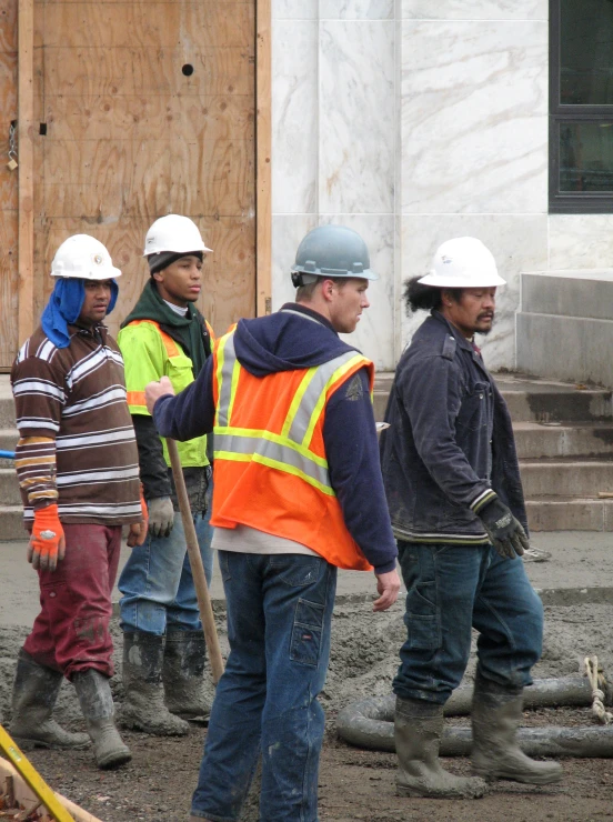 construction workers standing with each other looking around