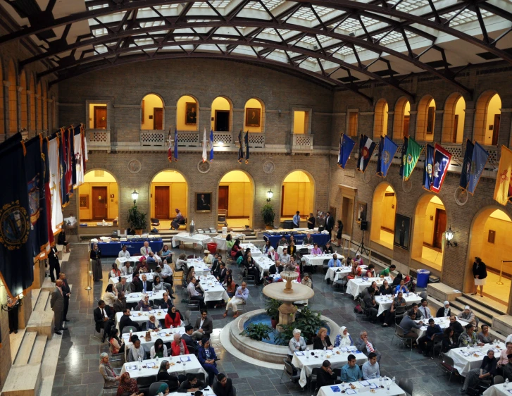 a big room with people eating around tables