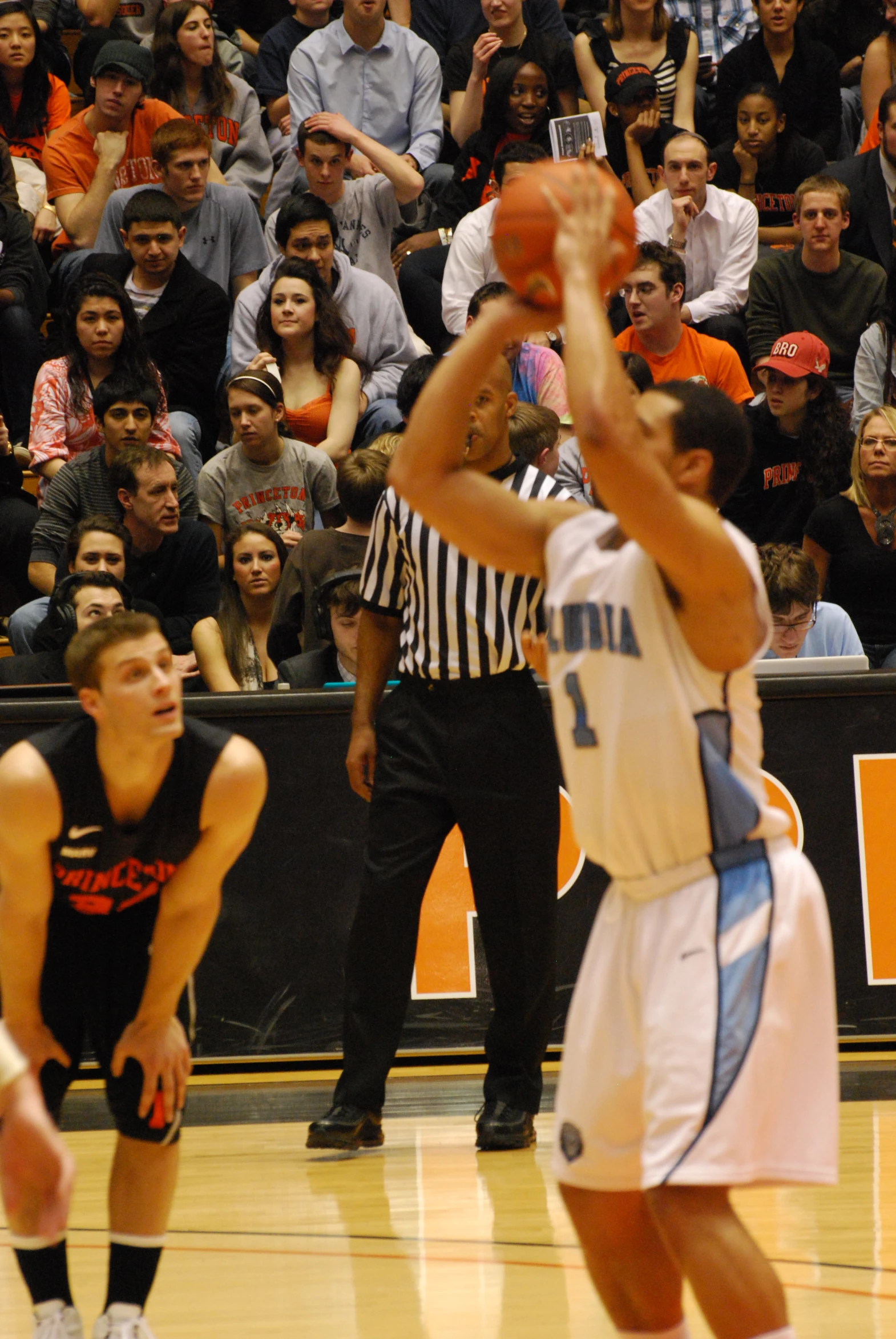 a boy playing basketball with an orange and white ball