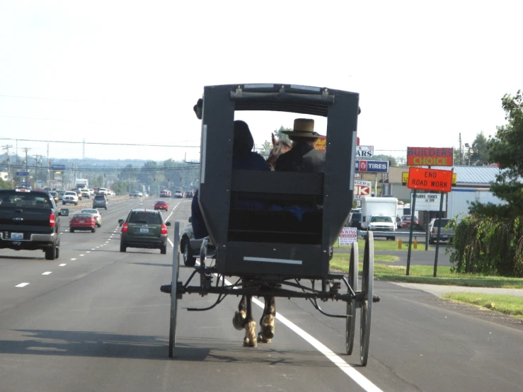 a horse drawn carriage traveling down a street