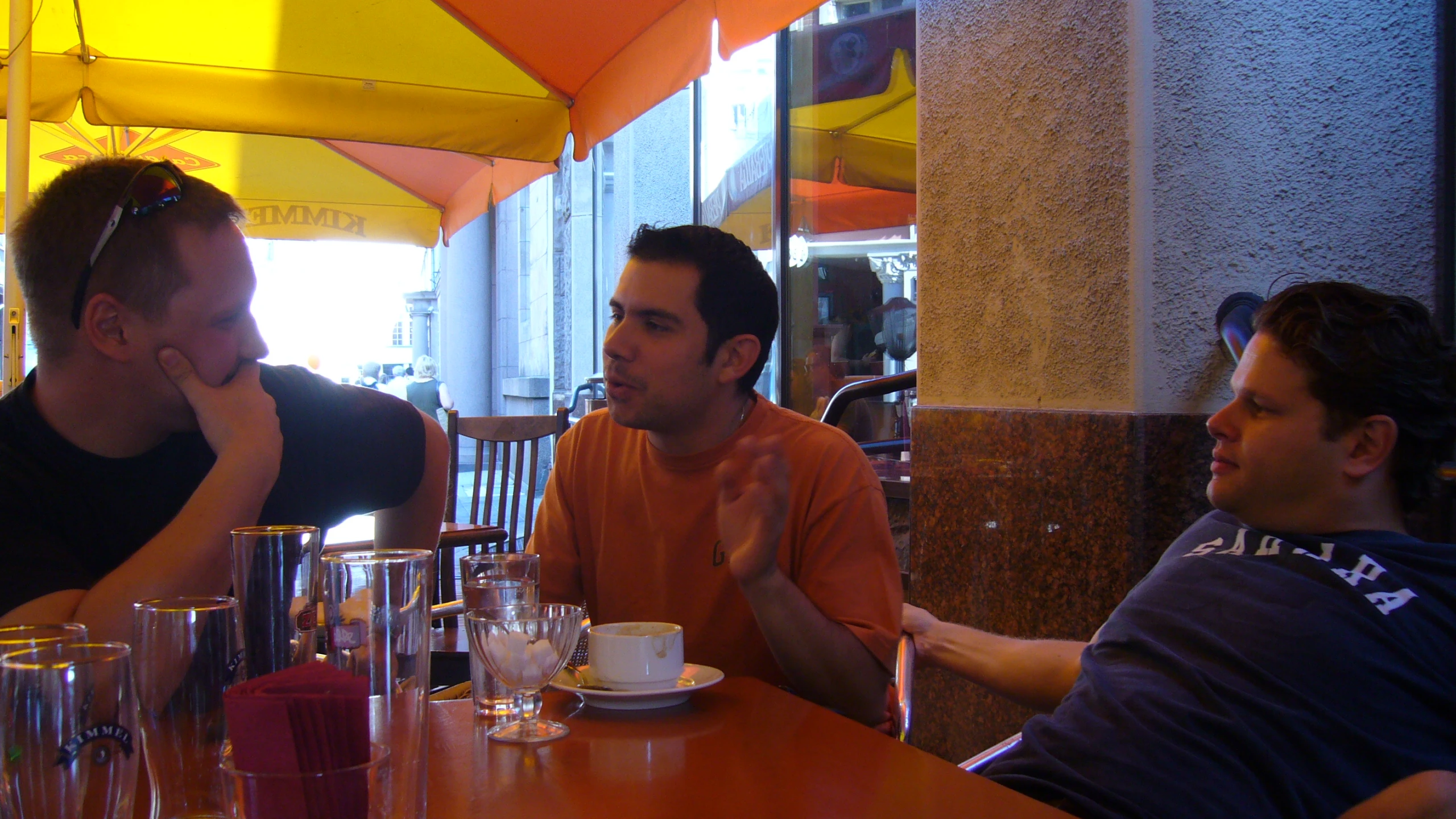 two men are sitting at the table talking